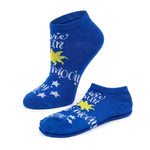 A pair of royal blue low-cut socks with a celestial graphic featuring a yellow sun, white stars, and the words 'are sure to moon' in white script, displayed on a clean white background.