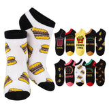 A set of novelty low-cut socks with food-themed graphics, featuring a pair of white socks with yellow and brown hamburger prints, and nine other black socks with different food prints like burgers, fries, hot dogs, pizza, soda, donuts, tacos, and sushi on a white background.
