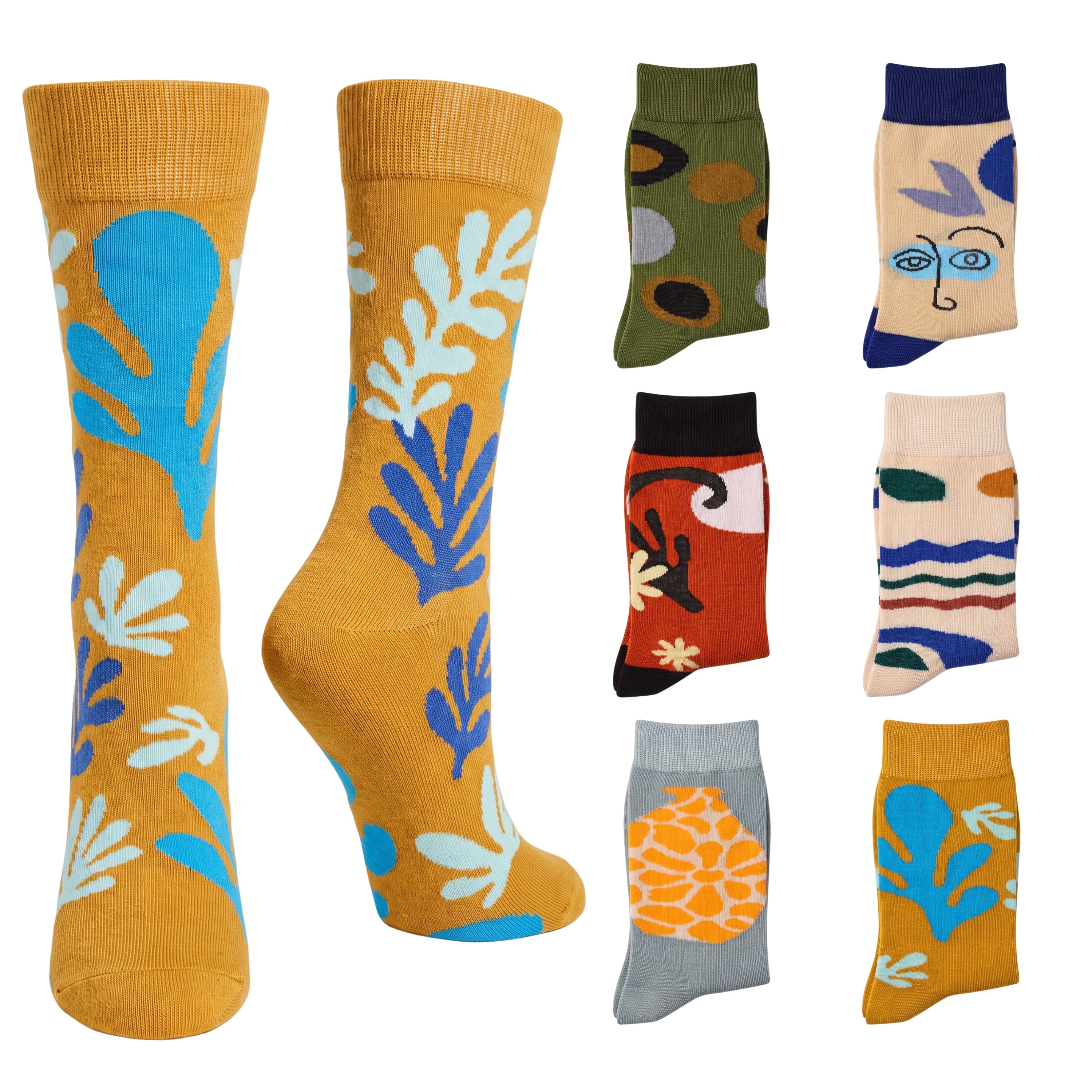 A set of colorful crew socks displayed on invisible forms against a white background, featuring various abstract and face-inspired patterns in mustard yellow, blue, green, red, beige, and gray.