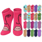 Set of pink socks with face designs and additional colorful socks displayed on a white background
