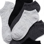 Set of gray and black ankle socks on a white background