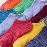 Colorful socks arranged in a pattern on a light background