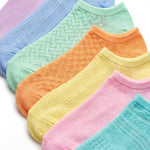 Set of colorful socks in various pastel shades on a white background