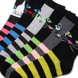 Four pairs of novelty socks arranged diagonally, each featuring a different cat face design with colorful embroidered eyes, noses, and whiskers, paired with bold horizontal stripes in various color combinations.