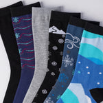 Set of colorful socks with winter-themed designs on a white background