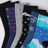 Set of colorful socks with winter-themed designs on a white background