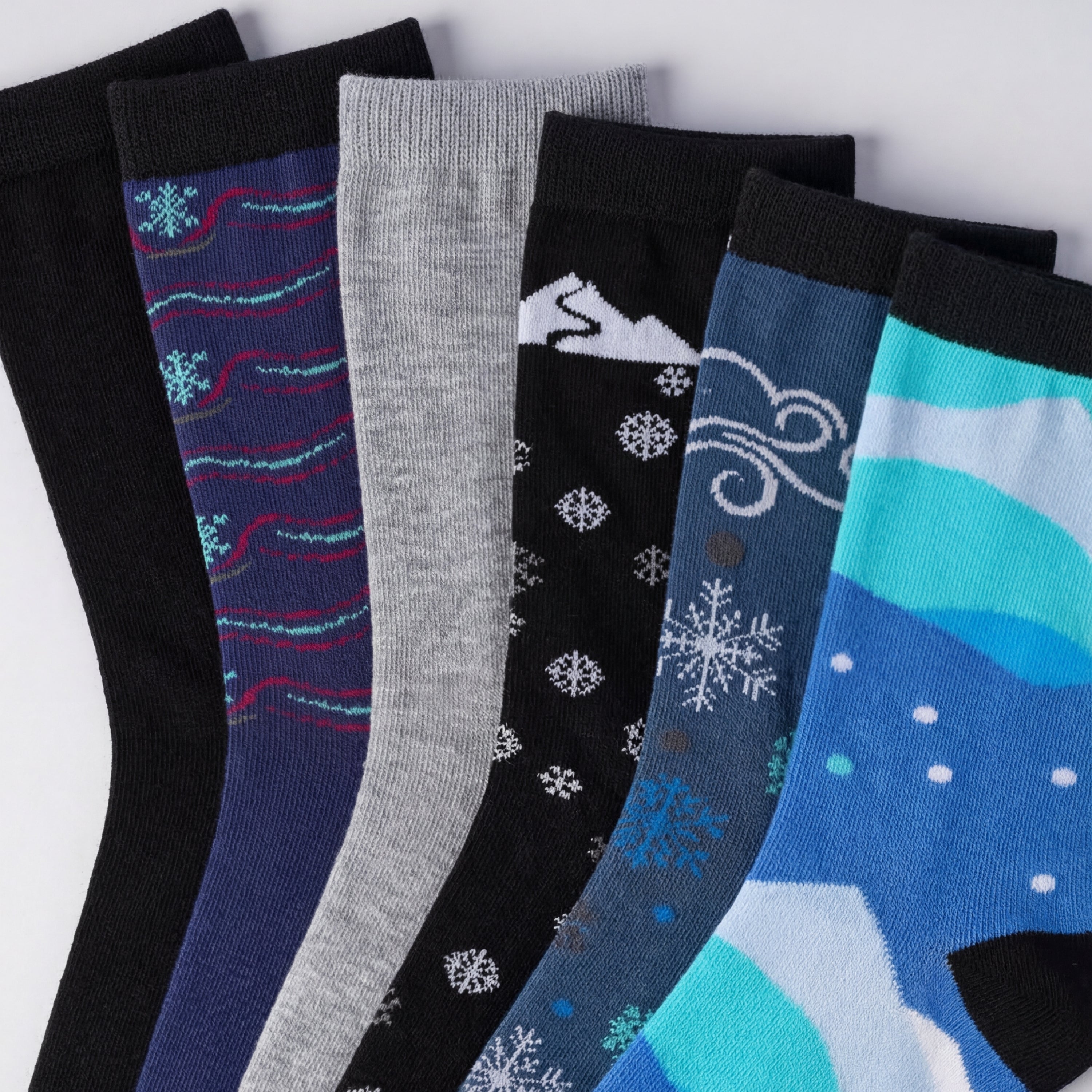 Set of colorful socks with winter-themed designs on a white background