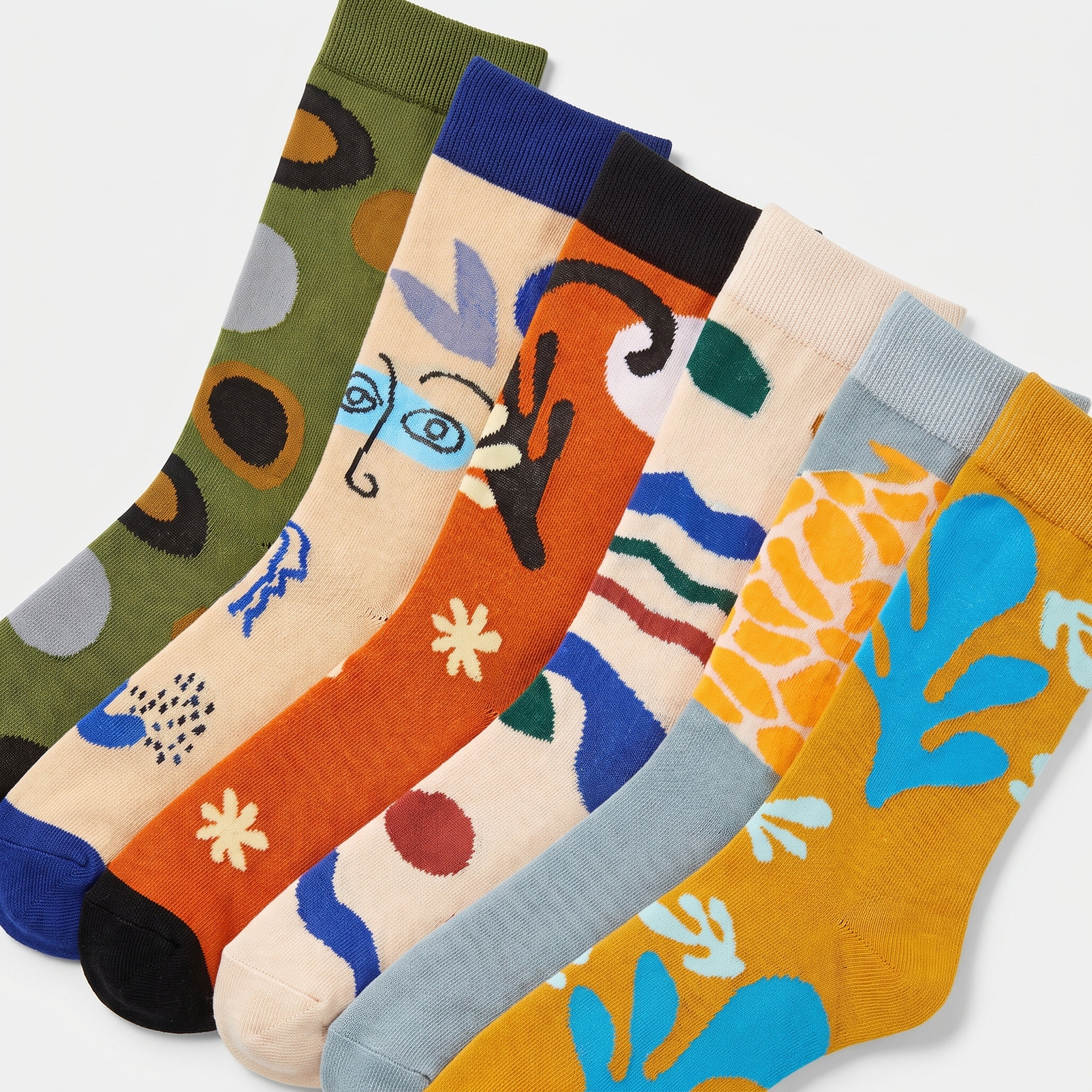 A set of six crew socks in assorted colors with abstract and artistic patterns, arranged diagonally on a light gray background.