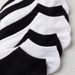 Set of black and white ankle socks on a light gray background
