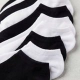 Set of black and white ankle socks on a light gray background