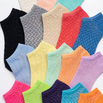 Assorted colorful ankle socks with textured patterns on a white background