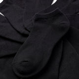 Stack of black ankle socks on a white background