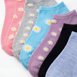 Set of colorful socks with daisy patterns on a white background