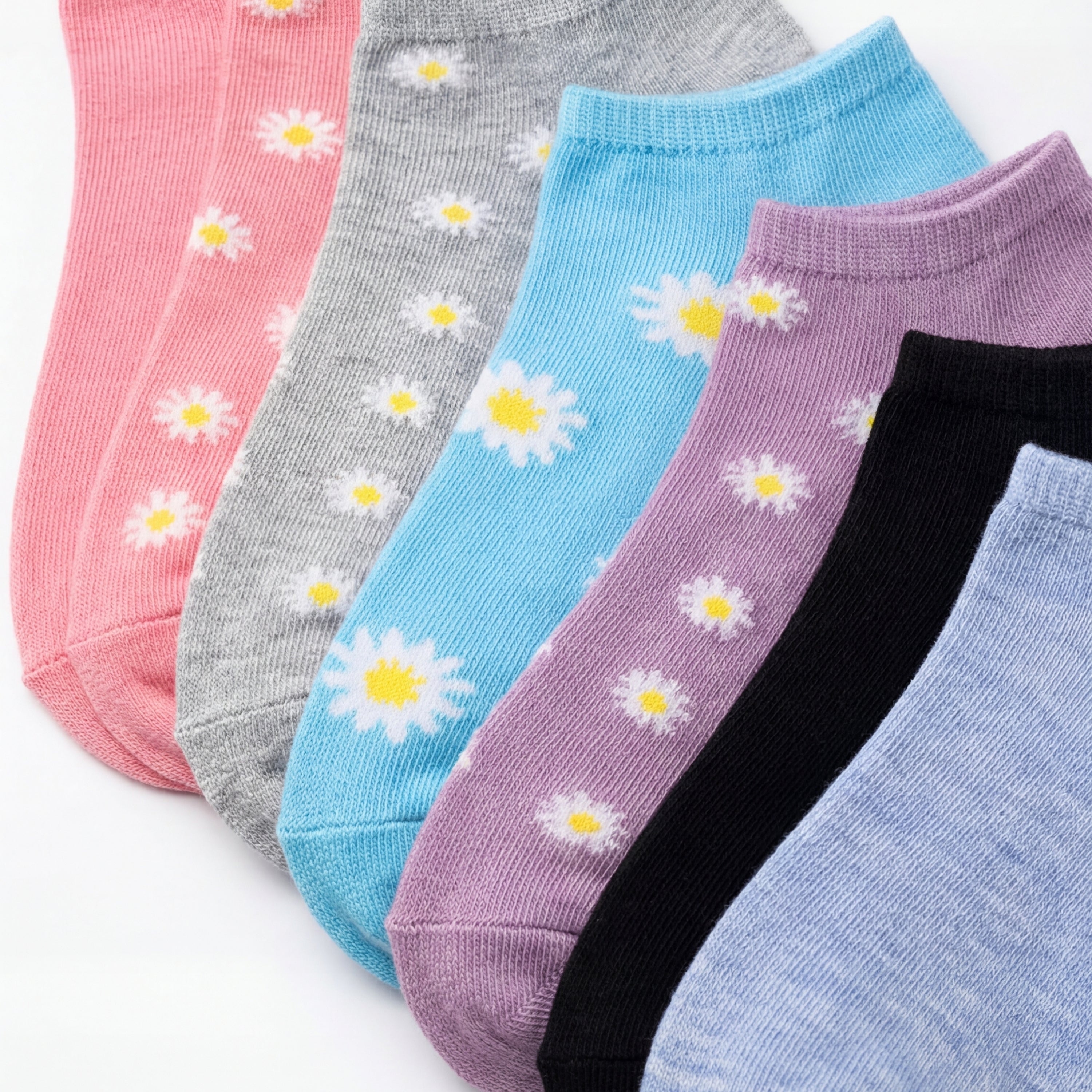 Set of colorful socks with daisy patterns on a white background