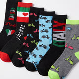 Six pairs of novelty socks with Italian-themed designs, including flags, text, and scooter patterns, arranged diagonally on a white background.