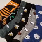 Six pairs of novelty socks arranged in a fan layout, featuring cute cartoon polar bear designs on various colors and patterns including stripes, leopard print, and solid blue.