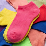 Colorful socks stacked on a multicolored background