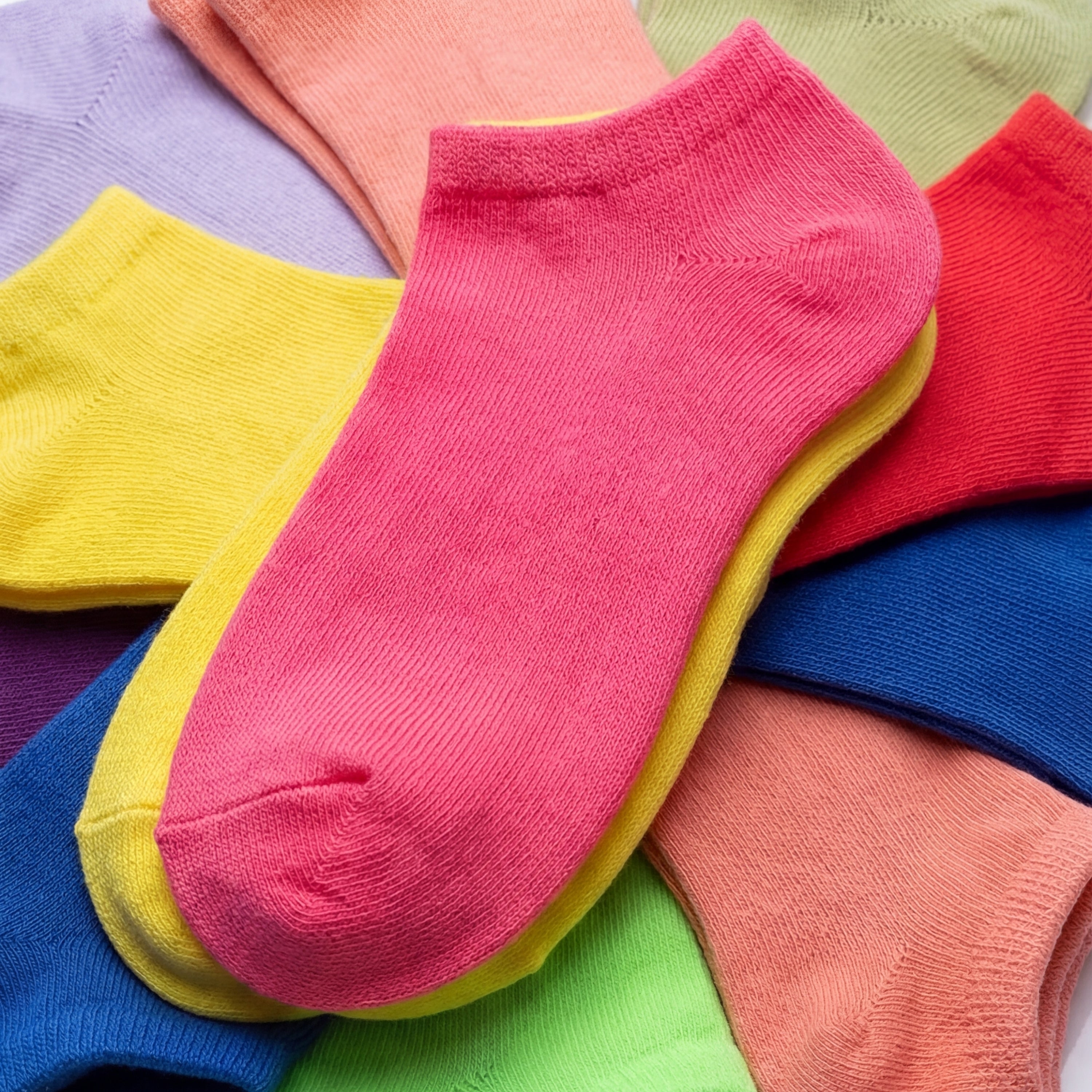 Colorful socks stacked on a multicolored background