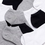 Set of black, gray, and white ankle socks on a light background