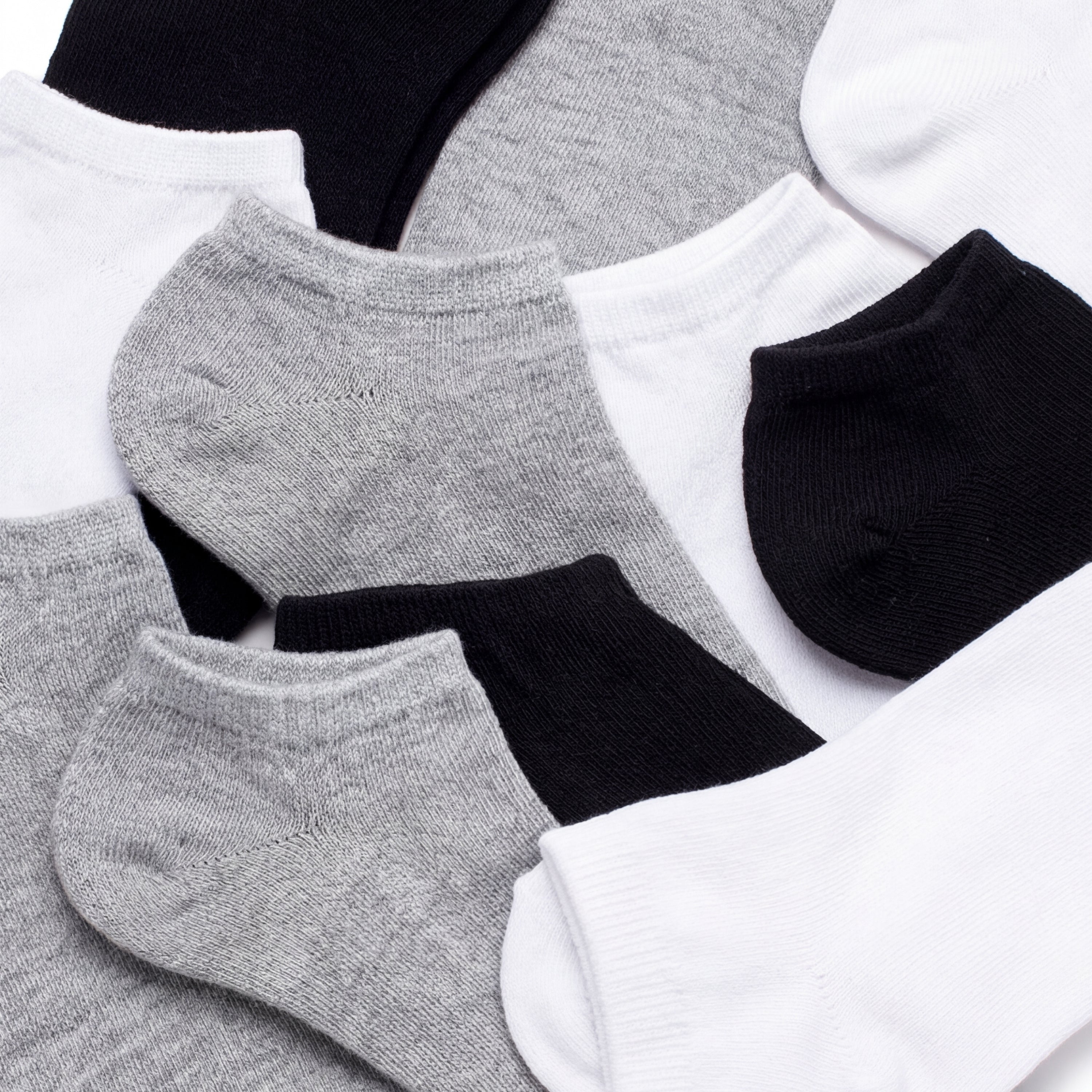 Set of black, gray, and white ankle socks on a light background