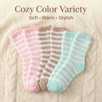 Three pairs of striped socks in pink, brown, and blue on a textured surface with 'Cozy Color Variety' text.