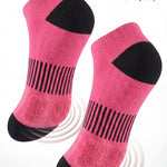 Pink socks with black accents on a white background, emphasizing cushioned sole comfort.
