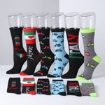 Six pairs of novelty crew socks displayed on clear plastic mannequin legs, with four additional pairs folded in front. The socks feature colorful Italian-themed prints including bicycles, the Italian flag, a tower, and the word 'ITALY'.
