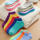 Colorful socks arranged on a towel with a wooden floor background