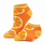 A pair of low-cut ankle socks with a bright orange and yellow citrus slice pattern, displayed on a clean white background.