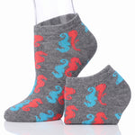 A pair of low-cut ankle socks on a white background, featuring a gray heather base with a repeating pattern of red and light blue seahorses.