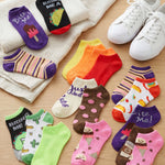 Colorful socks with various designs on a wooden surface