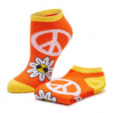 A pair of low-cut ankle socks in bright orange and yellow, featuring a large white peace sign and a white daisy with a yellow center on the front sock, with the folded sock showing a peace sign and daisy pattern on a clean white background.