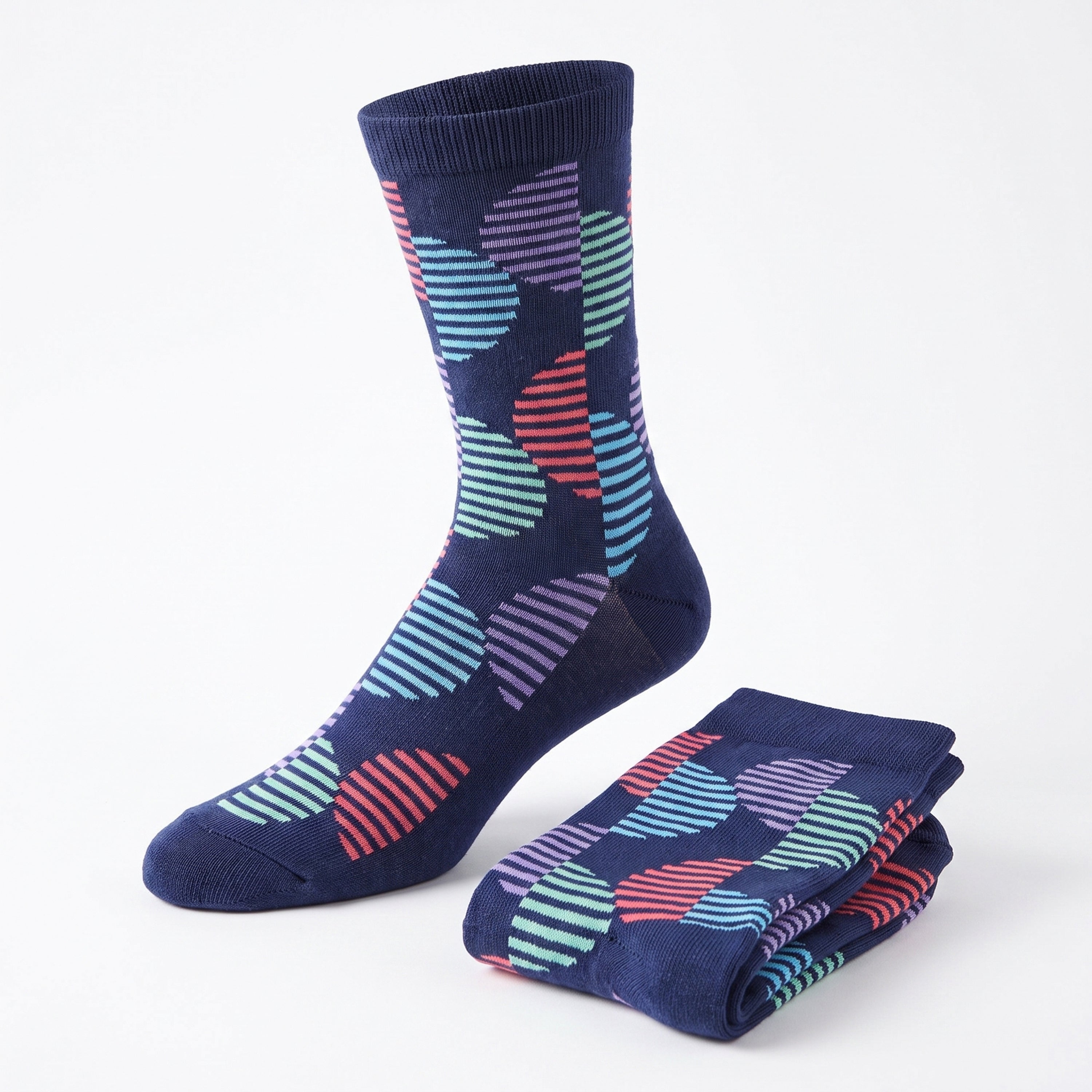 A pair of navy blue crew socks with a colorful striped and wavy geometric pattern, shown with one sock worn on a foot form and the other folded on a white background.