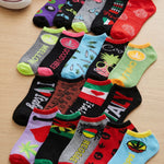Colorful socks with various designs and text on a wooden surface