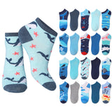 A set of children's ankle socks shown on a white background, featuring a large pair on the left in a light blue ocean-themed print with dark blue whales and coral, and a grid of 16 smaller sock designs on the right showing various patterns and colors.