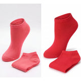 Two pairs of red ankle socks on a white background