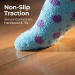 Blue sock with purple dots on a wooden floor, promoting non-slip traction.