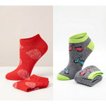 Two pairs of socks, one red with white patterns and the other gray with colorful designs, on a light background.