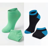 Two pairs of socks, one green and one black with blue accents, on a white background.