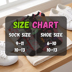 A size chart overlay showing sock and shoe size conversions, placed over a folded pair of patterned socks on a towel with white sneakers around it.