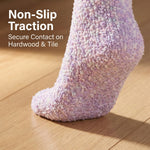 Purple textured sock on a wooden floor with text 'Non-Slip Traction' and 'Secure Contact on Hardwood & Tile'.