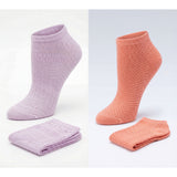 Two pairs of pink socks on a light gray background