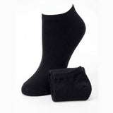 Pair of black ankle socks on a white background