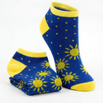 Blue socks with yellow sun patterns on a white background