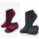 Two pairs of socks, one maroon and one gray, on a white background.