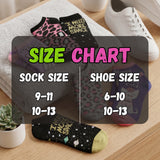 Size chart for socks and shoes with various pairs on a wooden surface.