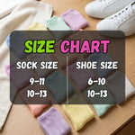 Colorful socks with a size chart on a wooden surface