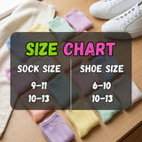Colorful socks with a size chart on a wooden surface