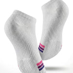 A pair of white low-cut ankle socks floating above a water ripple effect, with text at the top reading 'Cushioned Sole Comfort' and 'Soft impact protection every step.' The socks have small pink and purple striped accents near the toes.
