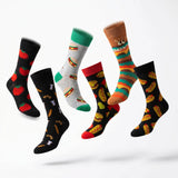 Six pairs of novelty crew socks floating against a clean white background. The designs include black socks with red tomatoes, black socks with hot dogs, a gray sock with green heels and hamburger prints, a brown sock with green and orange stripes and 'DANHT' text, and a black sock with taco prints.